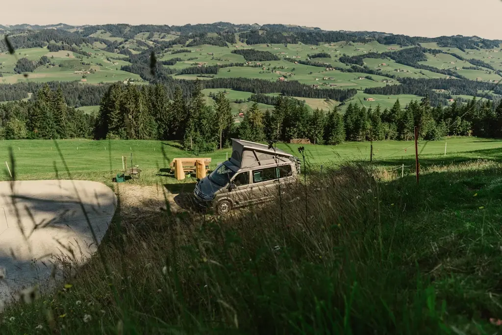 a camper van in nature under trees