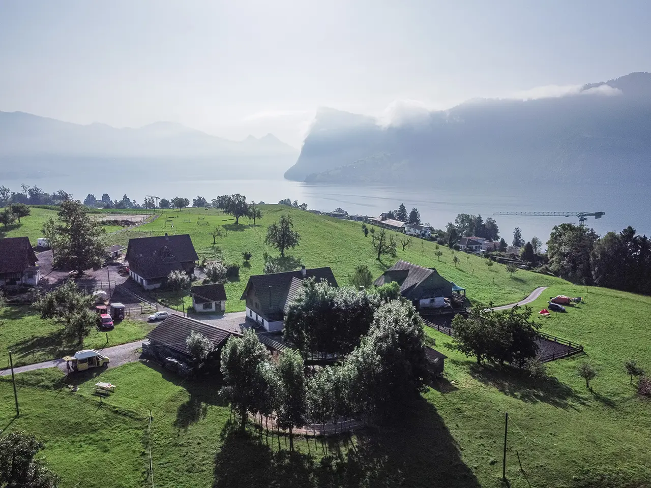 swiss meadows and mountains with a camper van in the middle