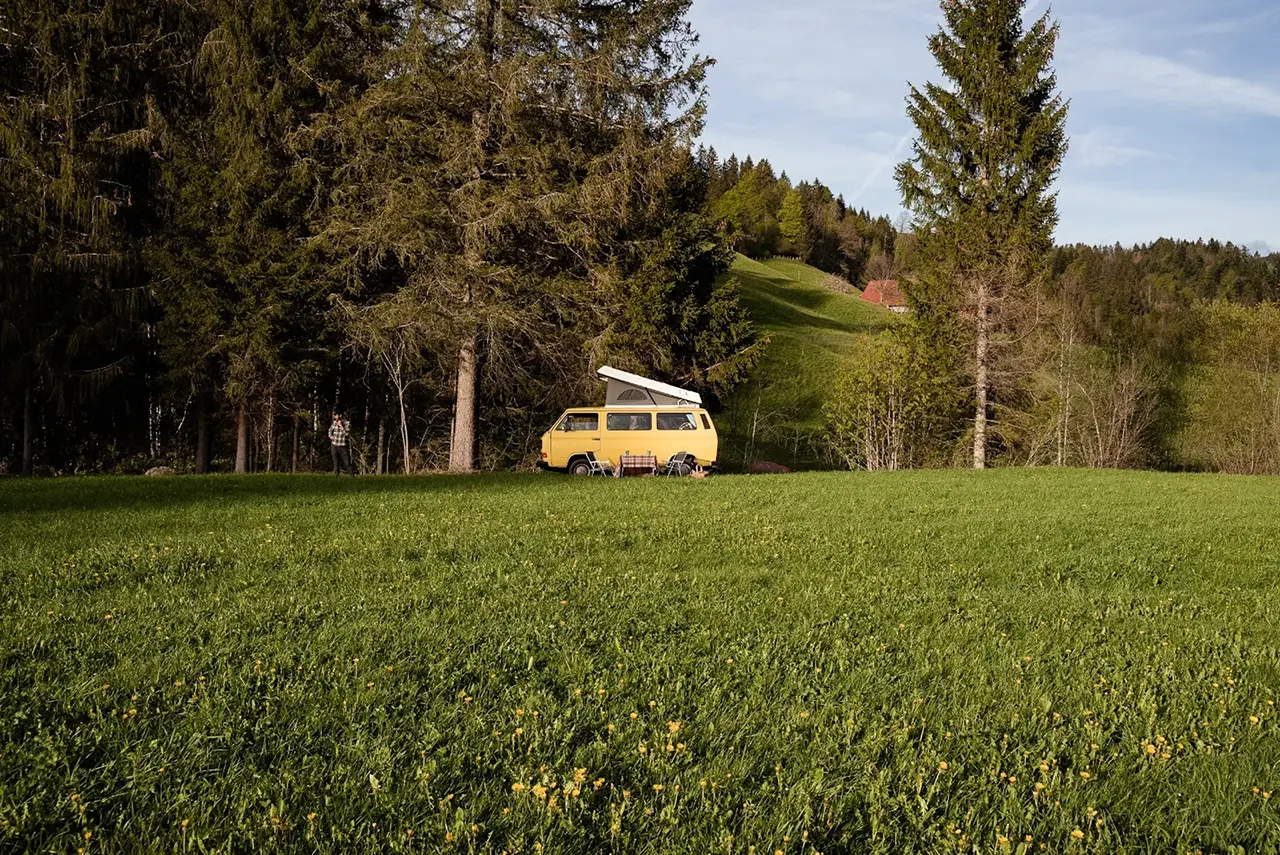 A camper van standing in a field in rural switzerland